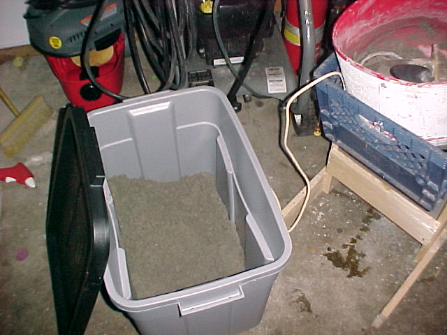 Sand is stored in a big plastic tub to keep it dry.jpg